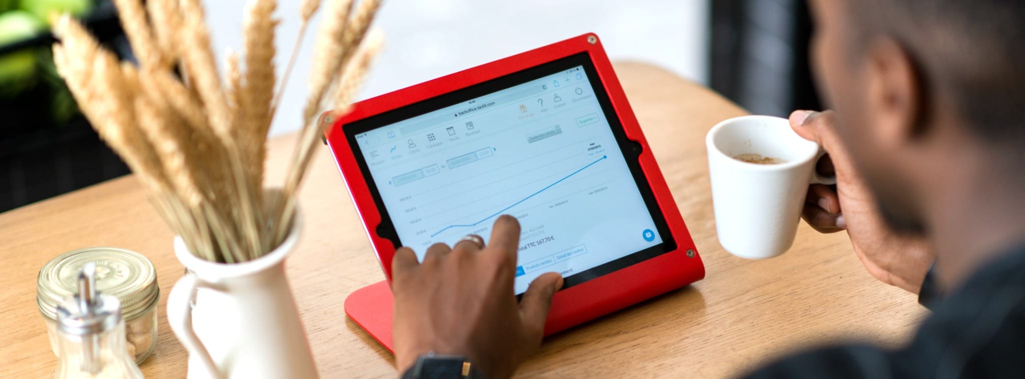 Commerçant qui suit son chiffre d'affaire sur sa tablette