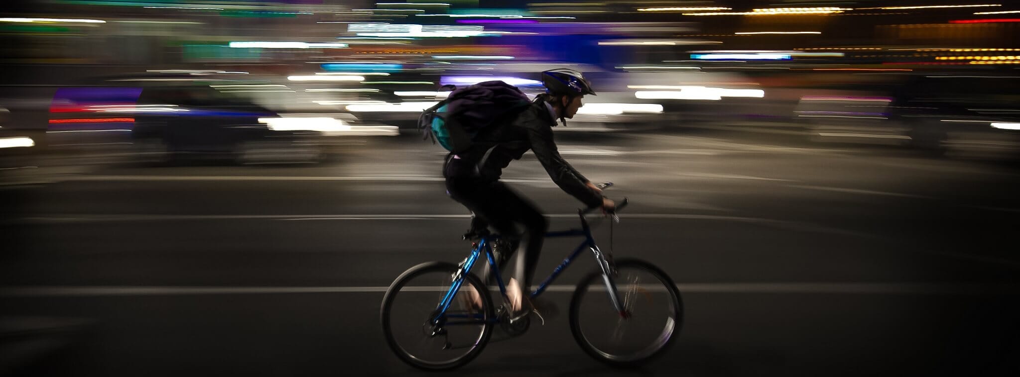 Livreur à vélo traversant la ville de nuit, illustrant la restauration boostée par la livraison à domicile.
